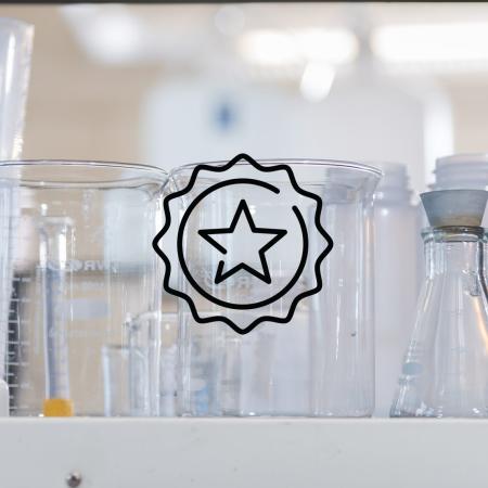 A graphic of a star is in front of lab test tubes.