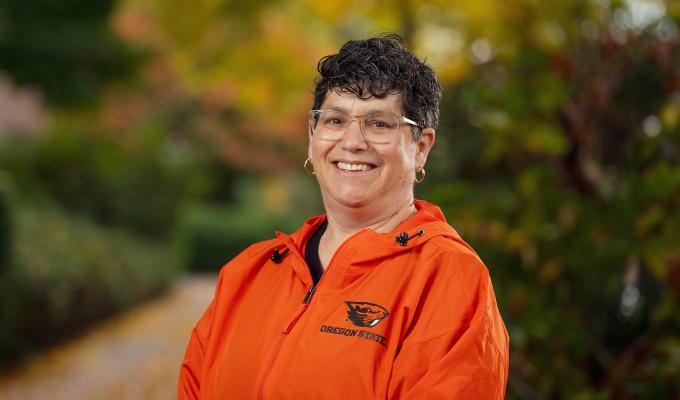 Dean Eleanor Feingold smiling in orange Oregon State jacket