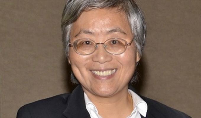 Photo of Dr. Annie Qu: Woman with short hair and glasses, smiling and wearing white collared shirt and blazer.