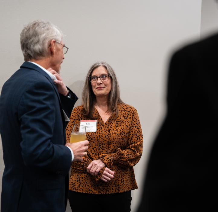 Two people converse during the 2025 Alumni Awards.
